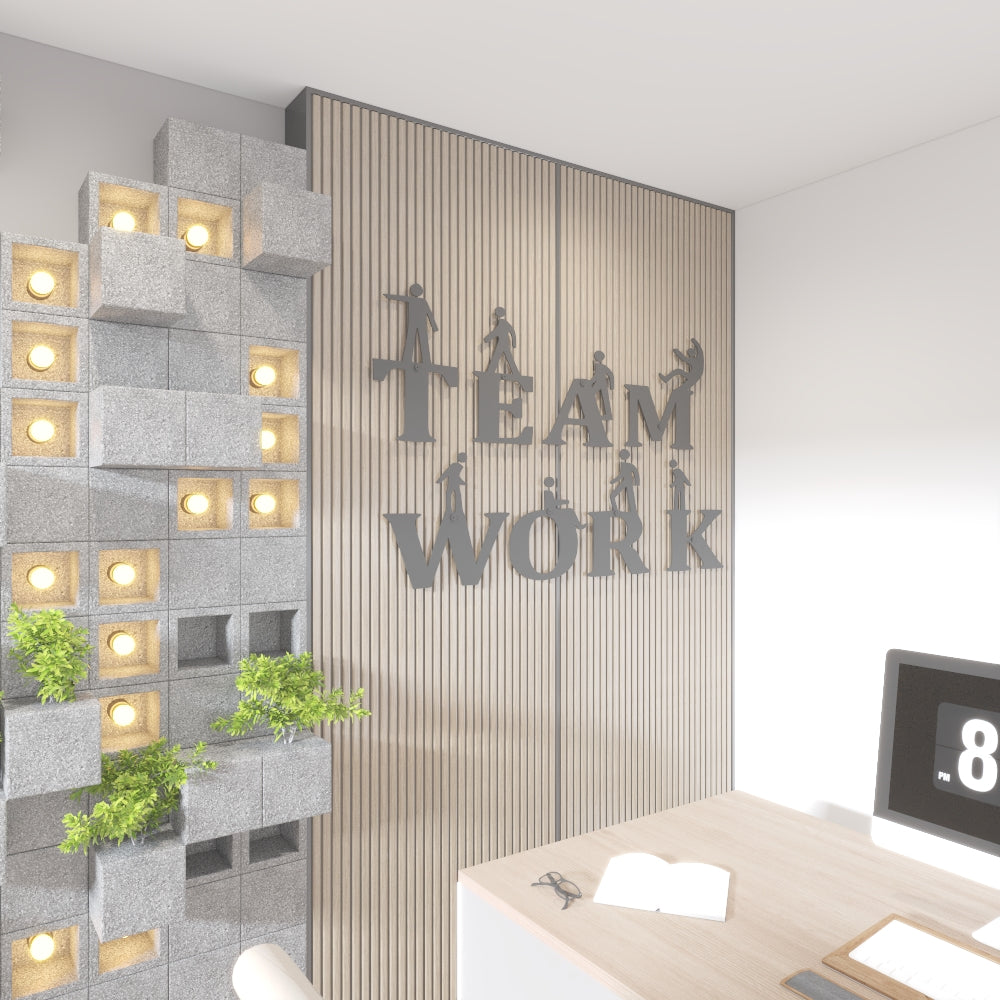 Modern office interior with 'Team Work' wall decoration and desk setup.