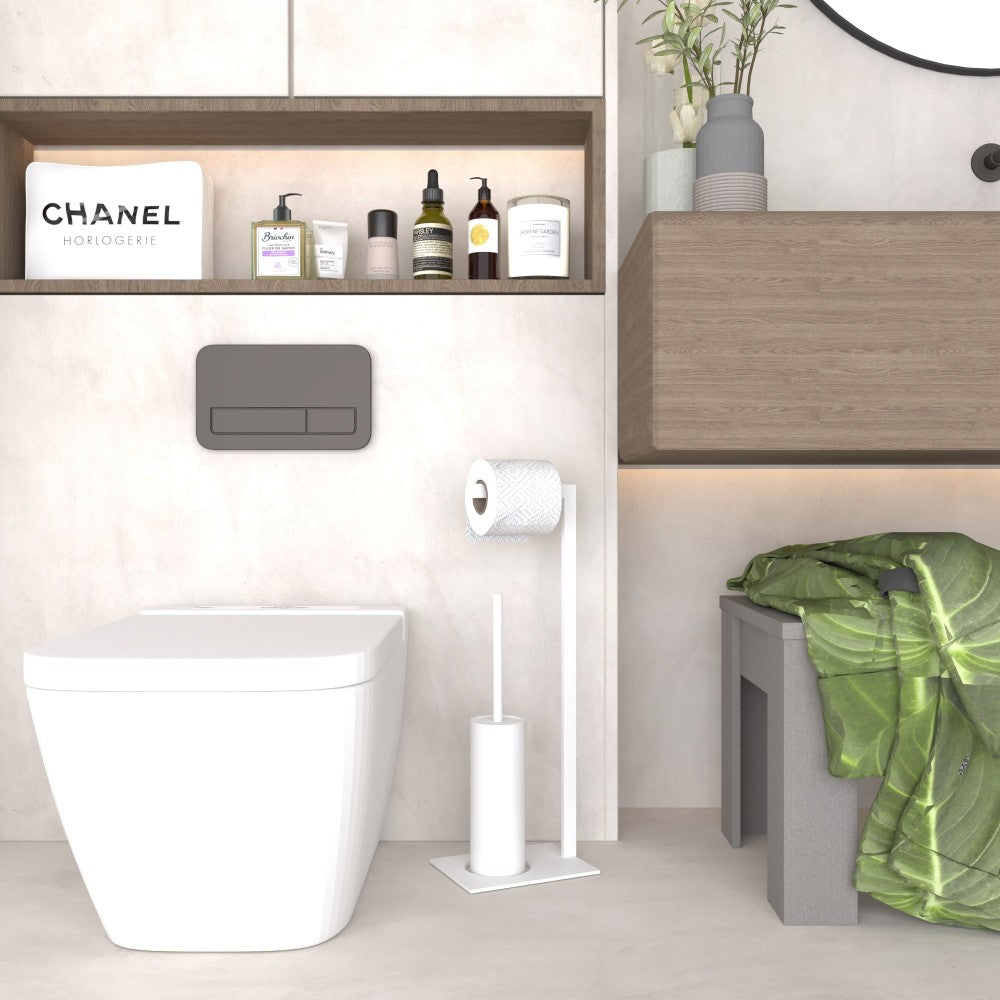 A white toilet paper and brush stand placed in a bright bathroom with natural accents, such as wooden cabinetry and greenery, complementing the modern decor
