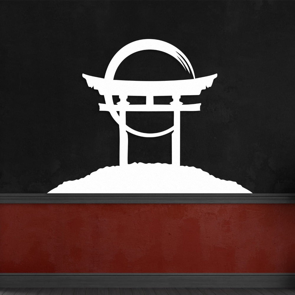 A white Torii gate metal wall art mounted on a black wall with a red accent panel, creating a bold visual contrast.
