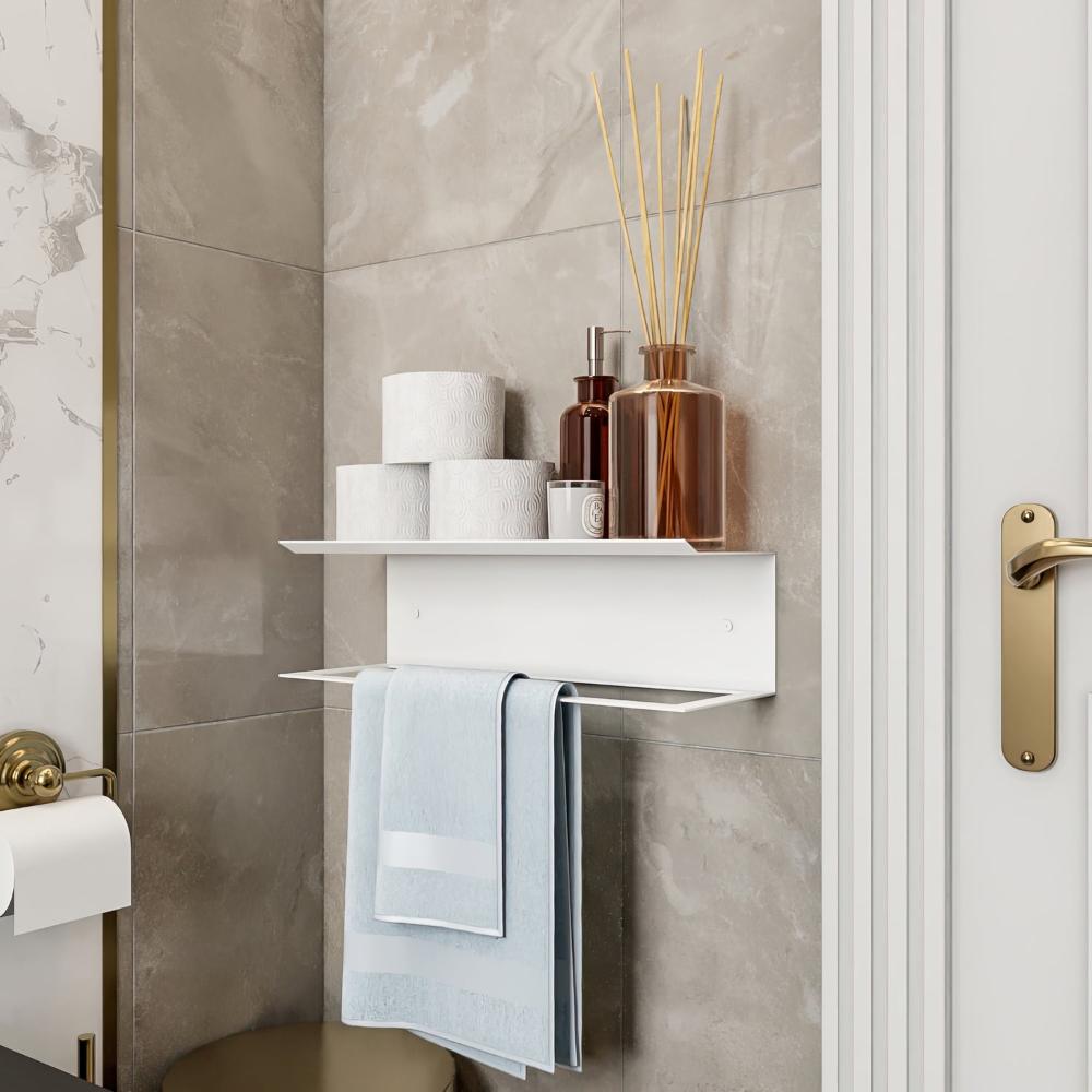 A white towel holder with a shelf, decorated with reed diffusers and toiletries, complementing a luxurious bathroom aesthetic.