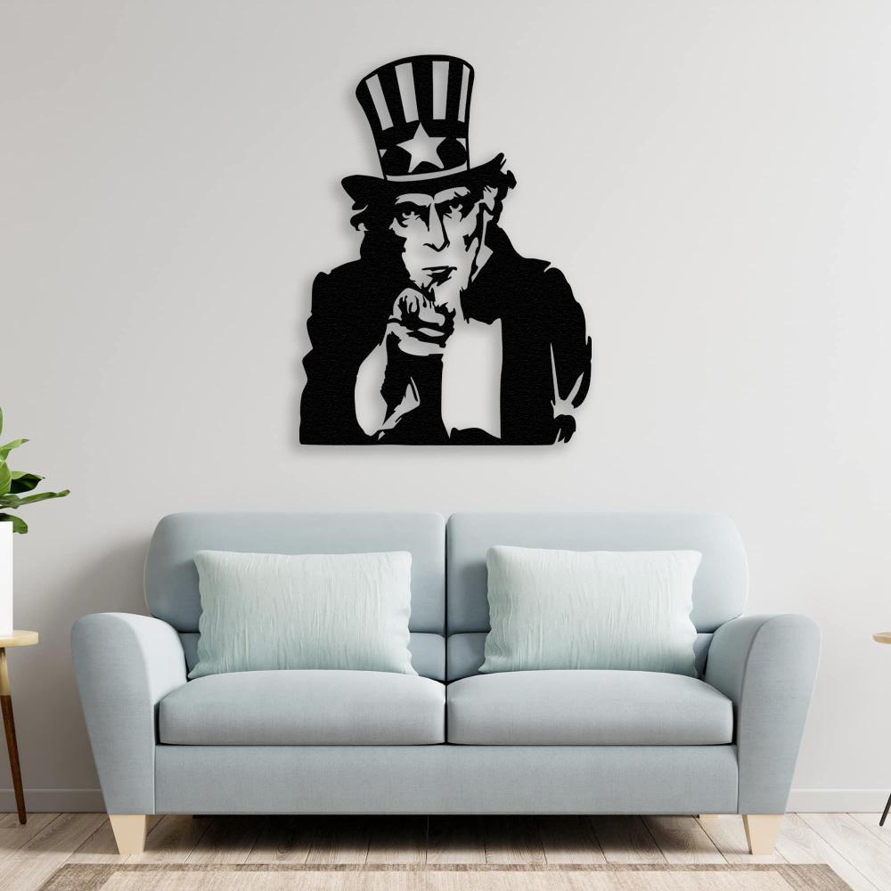 Uncle Sam black metal wall art placed above a light blue sofa with soft green pillows, adding character to a modern living room.