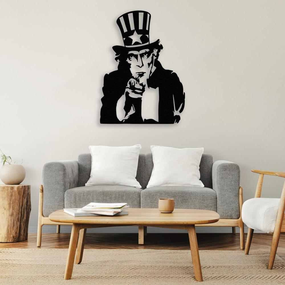 Uncle Sam black metal wall art mounted above a modern gray sofa with white pillows, creating a patriotic and minimalist decor theme.