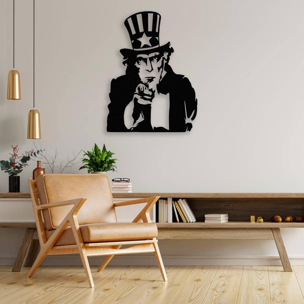Uncle Sam black metal wall art installed above a wooden console table with a tan leather chair, styled with plants and decorative items for a cozy ambiance.