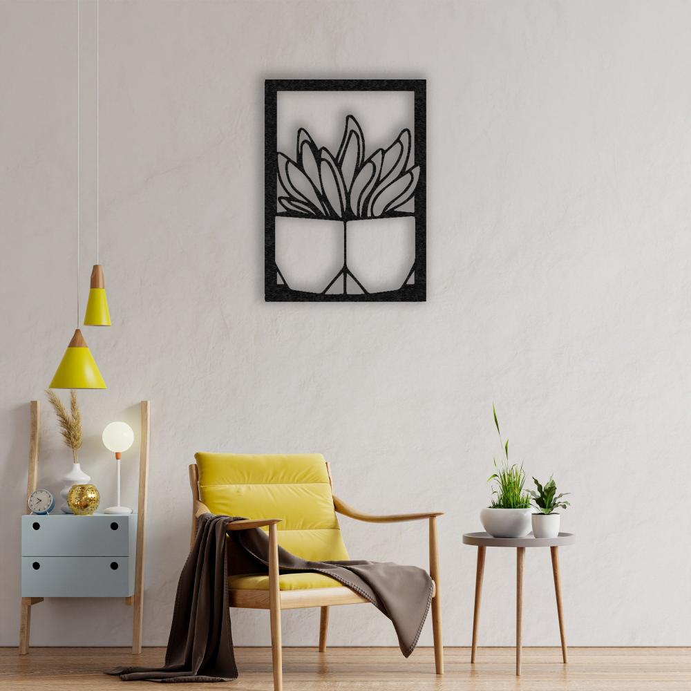 A cozy reading nook with a yellow accent chair, a small round table with plants, and a black "Vase with Succulent" metal wall art on a soft beige wall, complemented by yellow pendant lights.