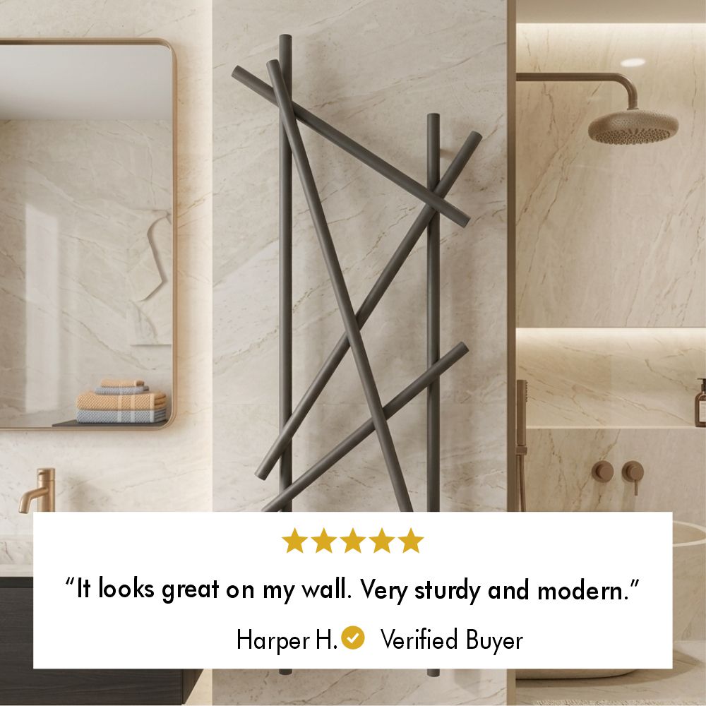 Five-star customer review from verified buyer Harper H. saying the branch towel rack looks great on the wall and feels sturdy and modern.