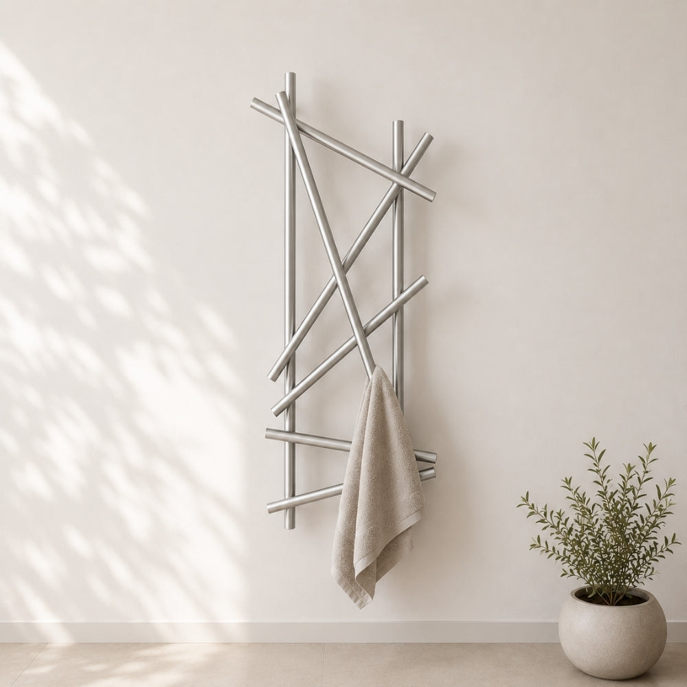 Satin nickel wall mounted branch towel rack holding a beige towel on a light bathroom wall.