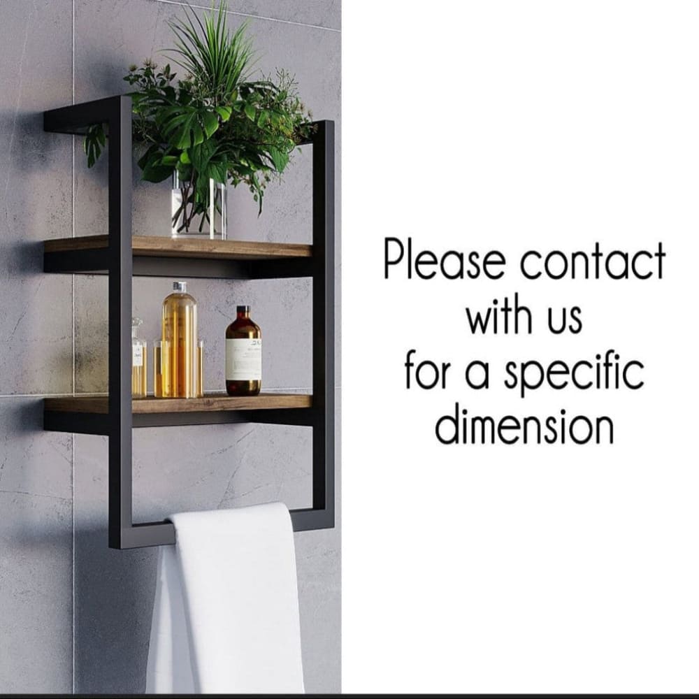A black wall-mounted shelf with two wooden tiers, holding a plant, glass bottles, and a white towel hanging below. The right side shows text suggesting to contact for specific dimensions.