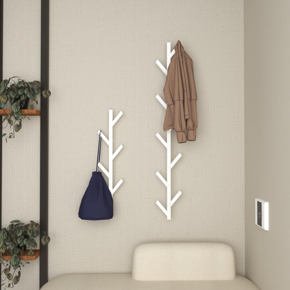 A modern entryway featuring wall-mounted, tree-shaped coat racks in white. The minimalist design adds a stylish touch, perfect for hanging coats and bags. The racks are positioned above a cozy beige bench, complemented by green potted plants for a welcoming and organized space.
