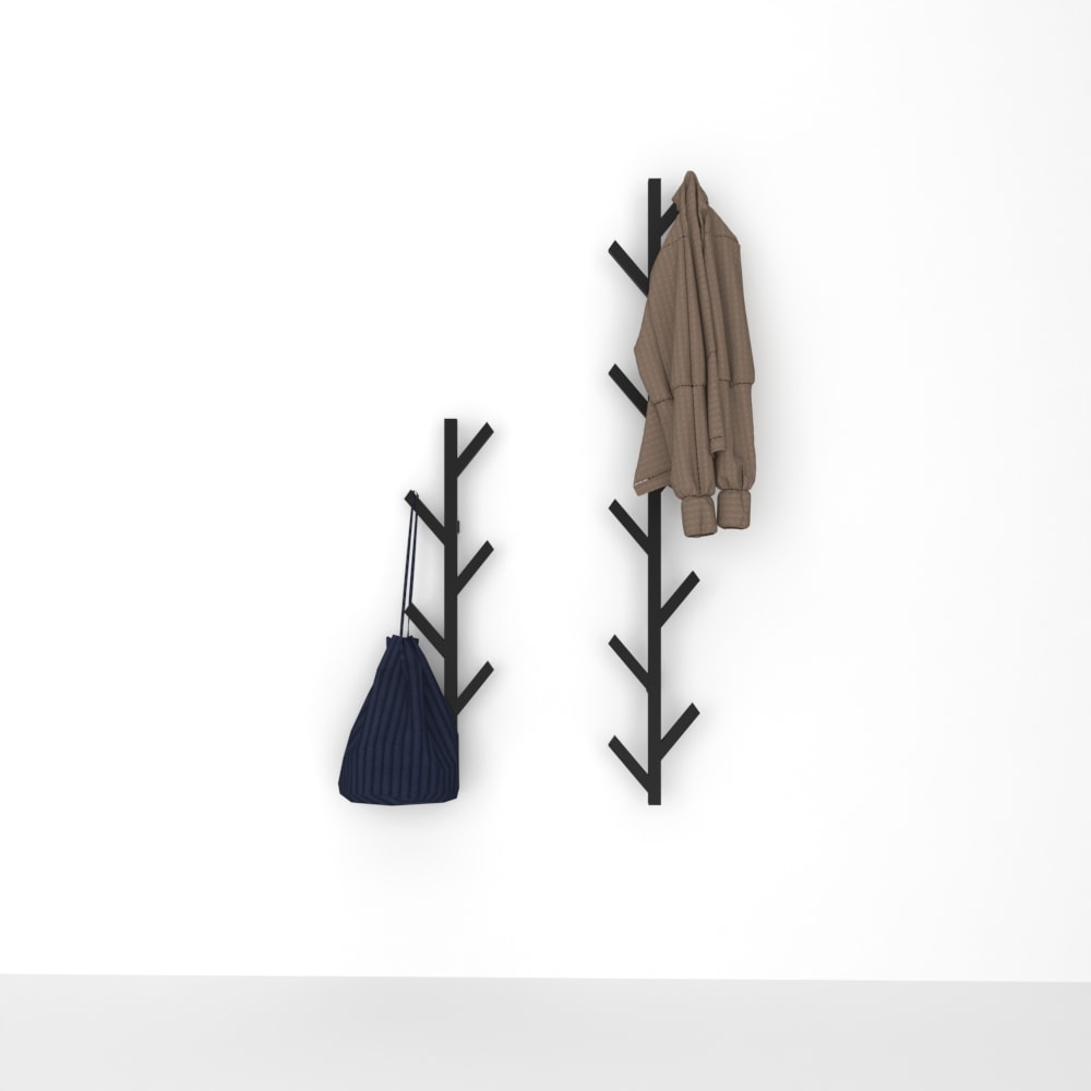 Wall-mounted tree-shaped coat racks in black metal, one holding a brown jacket and the other a blue bag, displayed against a plain white wall for a minimalist and modern look.