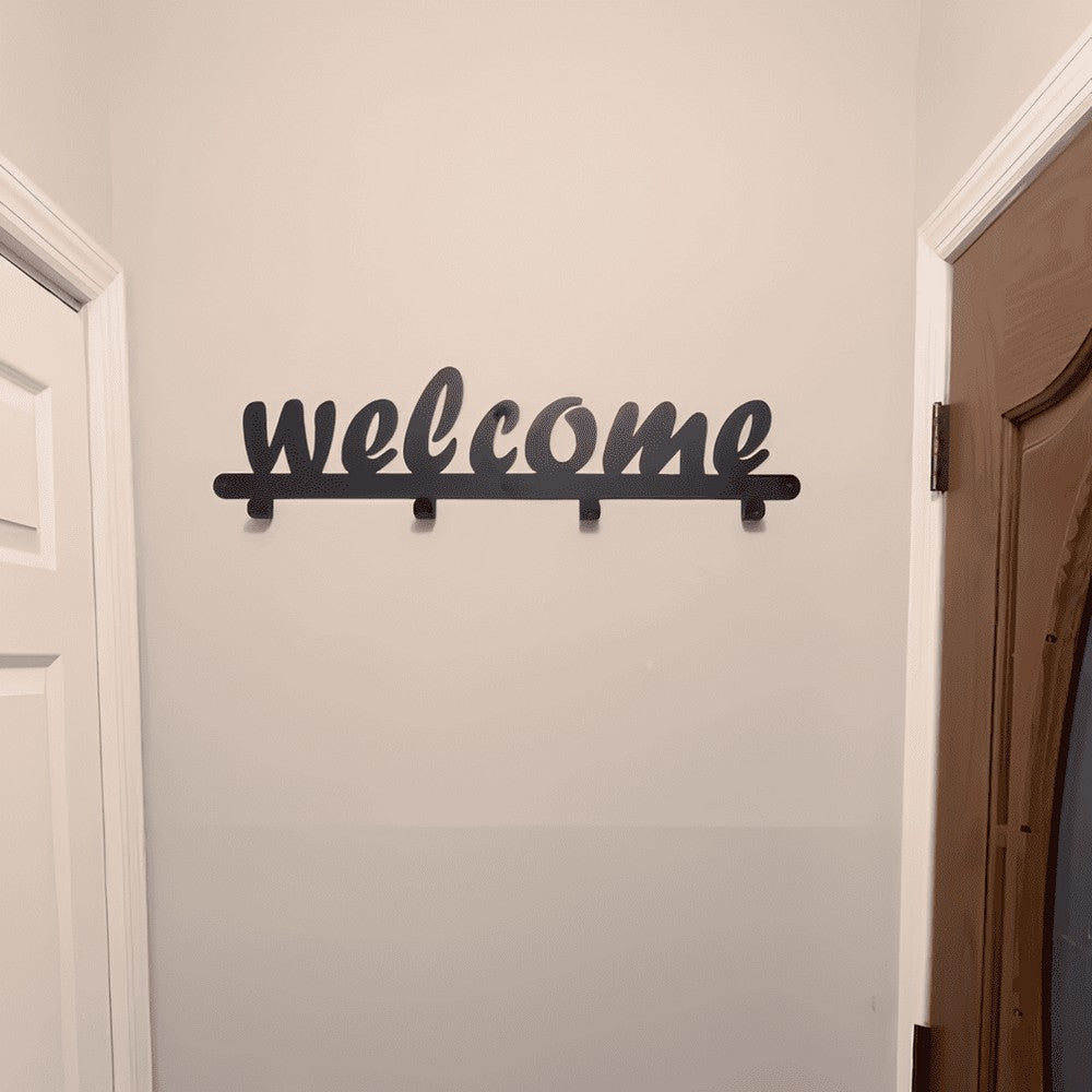 A black metal wall-mounted coat rack with the word "welcome" in cursive, displayed in a hallway. The sleek, minimalist design adds a decorative touch while offering functional hooks for coats, bags, or hats. Perfect for enhancing entryway decor.