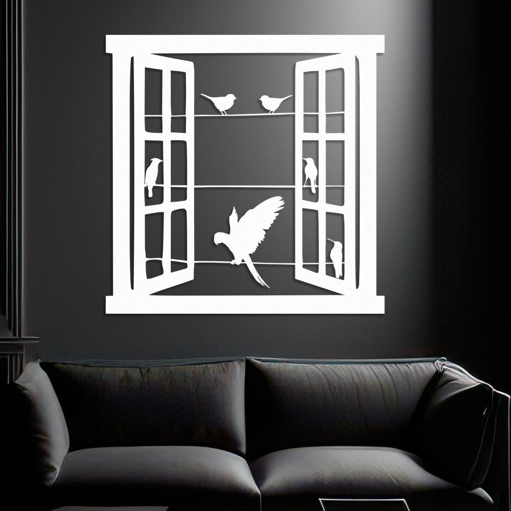 Modern white wall art of an open window with bird silhouettes perched on wires and a parrot in mid-flight, mounted on a dark gray wall above a sleek black sofa.