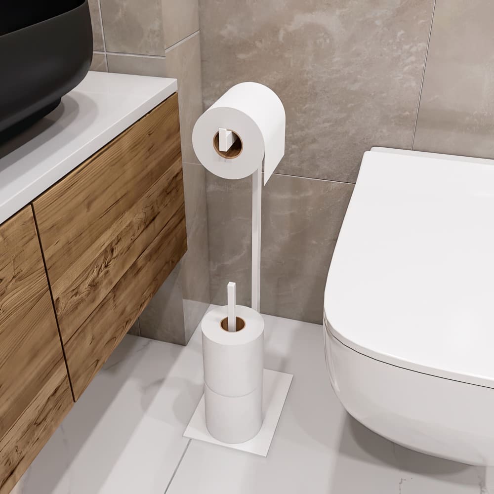 A sleek white toilet paper holder stand with a minimalist design, placed beside a wooden vanity and modern toilet in a neutral-toned bathroom.