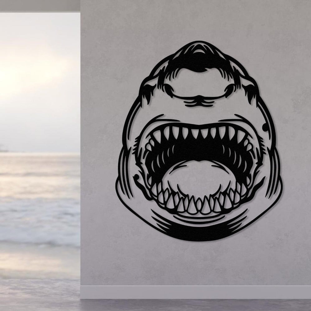 Black metal shark wall art displayed on a white wall with an ocean view in the background.