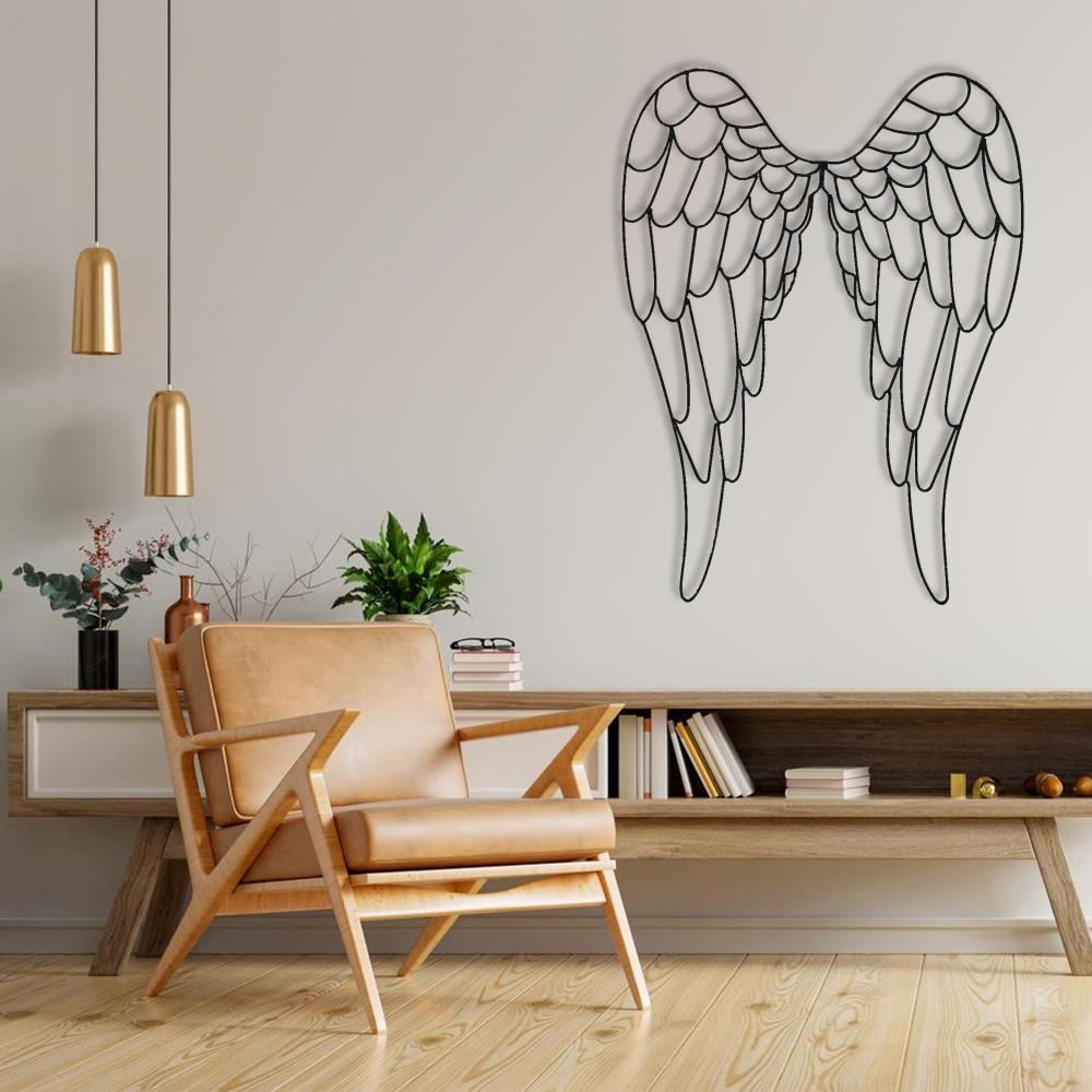 Black angel wings metal wall art showcased on a neutral wall above a modern console table, paired with a stylish tan leather armchair and decorative plants, enhancing the cozy and elegant interior design.