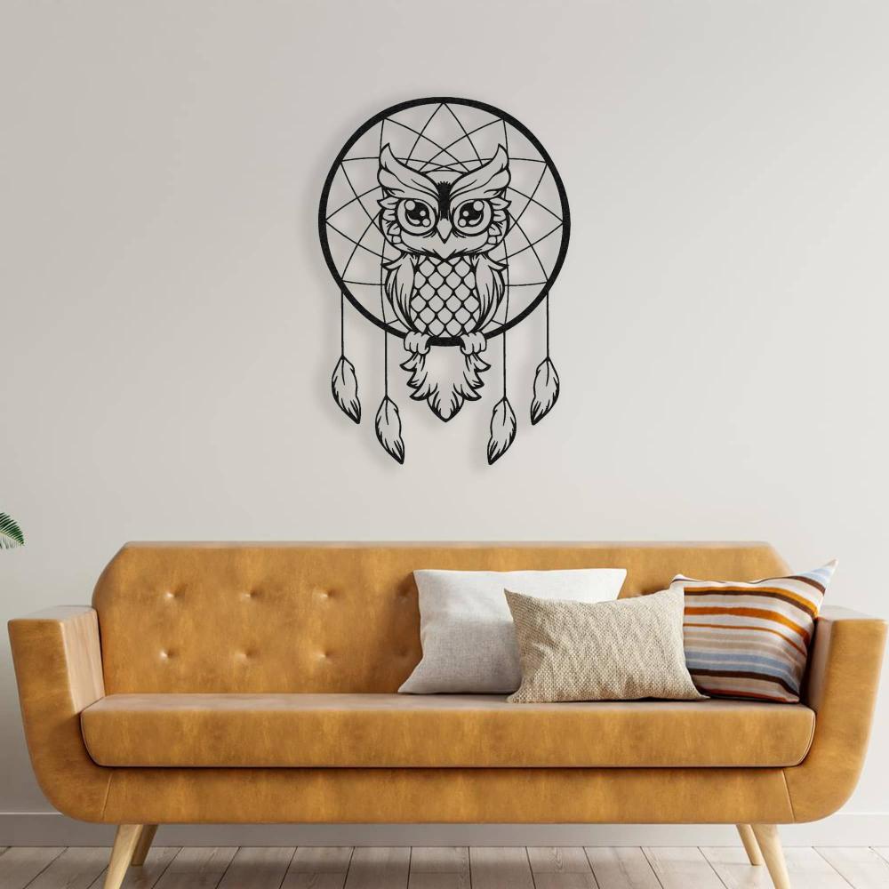 Black metal wall art of a wise owl dreamcatcher mounted above a mustard yellow sofa with accent pillows, creating a bold decor statement.