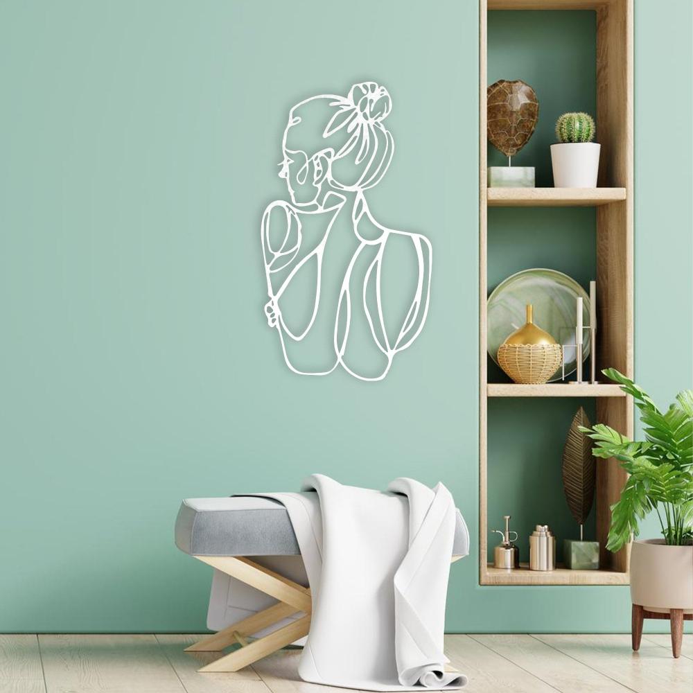 A modern space with a light green wall showcasing a white metal wall art of a minimalist woman’s figure, next to wooden shelves with decorative items.