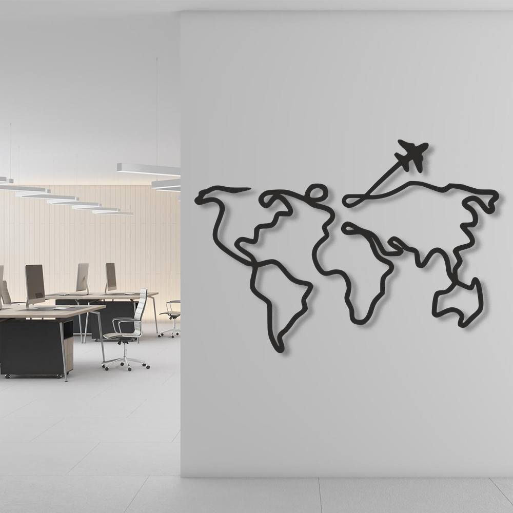 World map wall art with an airplane on a white wall in an office setting