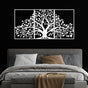 Three-piece white metal wall art featuring a life tree with intricate branches and leaves, mounted on a black wall above a modern bed. The bed is styled with gray and houndstooth-patterned pillows, white bedding, and a beige throw blanket, creating a striking contrast.