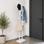 White freestanding 6-hook metal coat rack with jacket, cap, tote bag, and umbrella in a modern entryway.