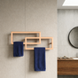 Bathroom with a metal towel rack holding blue towels against a tiled wall.