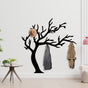 Tree Branch Shaped Coat Rack with hanging coats, demonstrating capacity in an entryway setting.