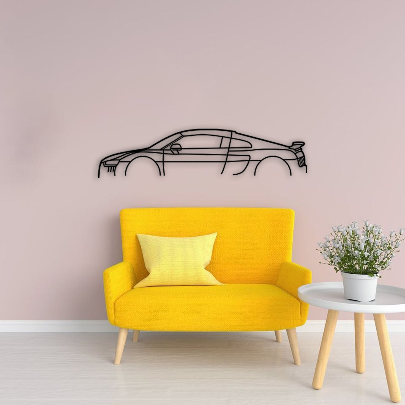 Audi R8 car silhouette metal wall art displayed above a yellow sofa.