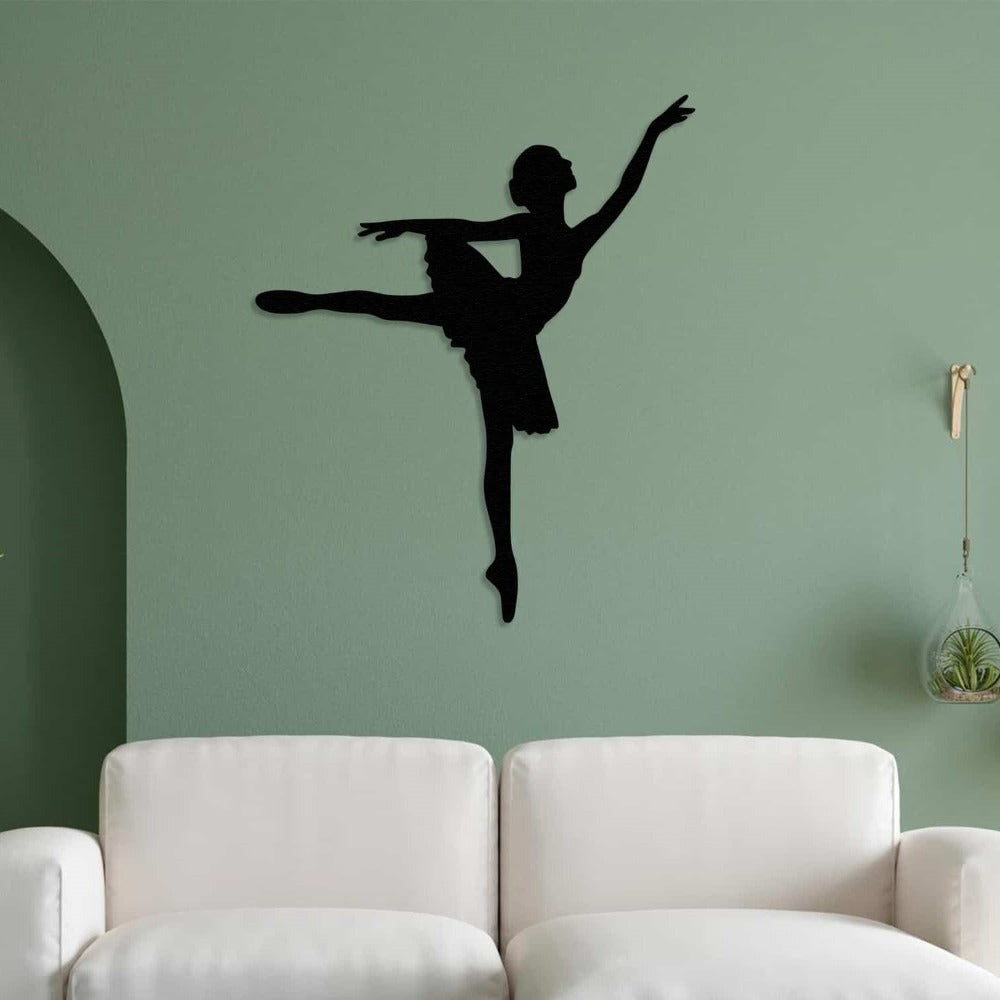 Black ballerina metal wall art mounted on a soft green wall, above a white sofa, creating a serene and artistic ambiance in the living room.
