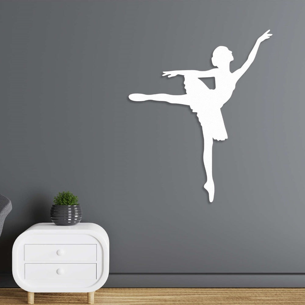 White metal wall art of a ballerina in a graceful pose, styled on a dark gray wall for a contemporary interior.