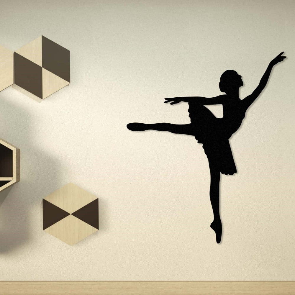 Classic black metal wall art of a ballerina, displayed against a neutral wall with modern decorative accents.