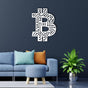  White Bitcoin-themed wall art featuring a circuit board pattern, displayed on a dark blue wall above a modern blue sofa with colorful pillows and a round ottoman, complemented by a green plant in a metallic pot.