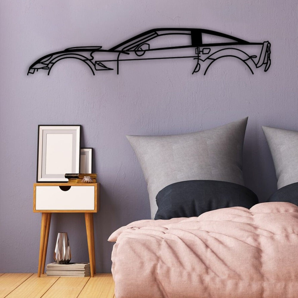 Chevrolet Corvette car silhouette metal wall art displayed above a bed.