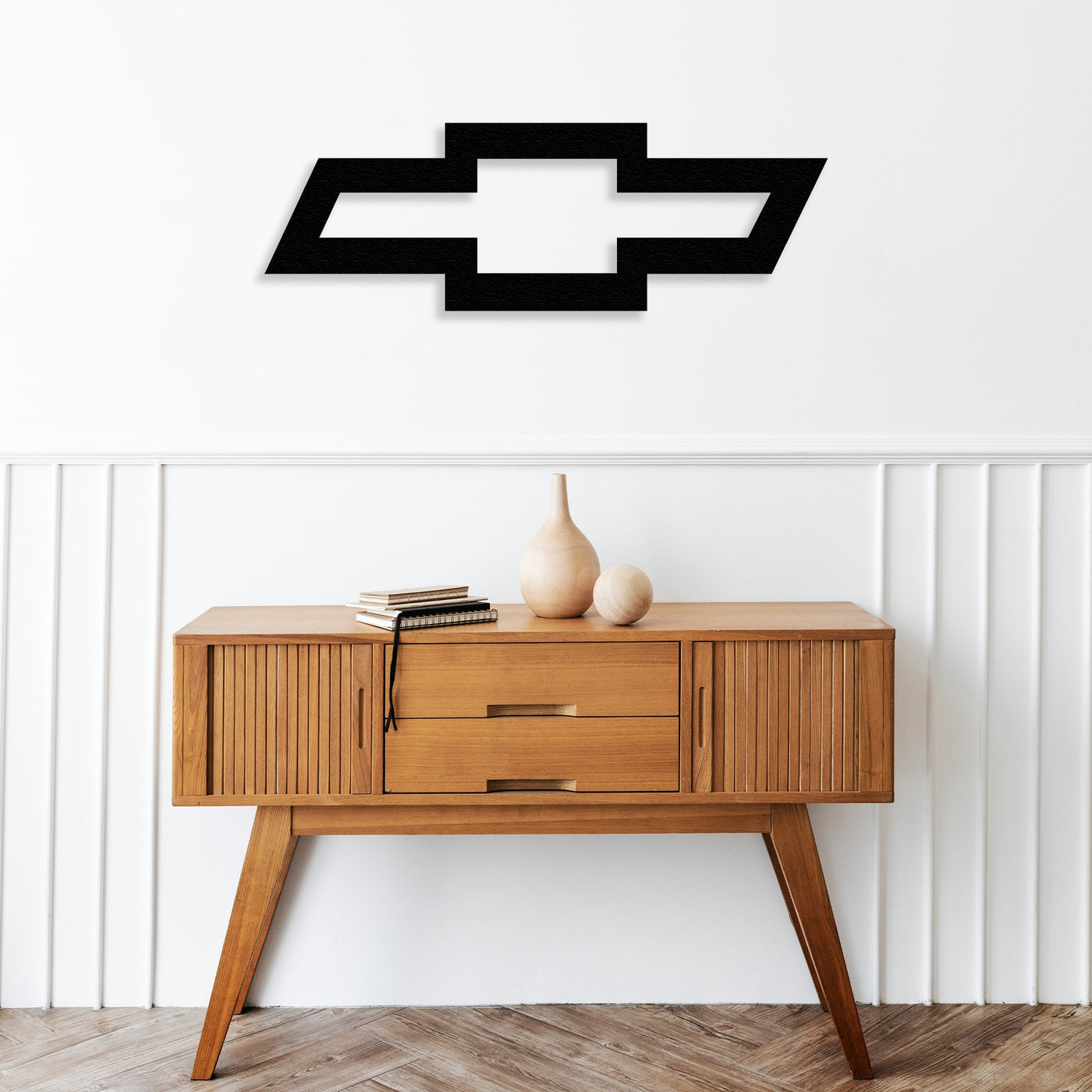 chevrolet metal wall art decor on the table