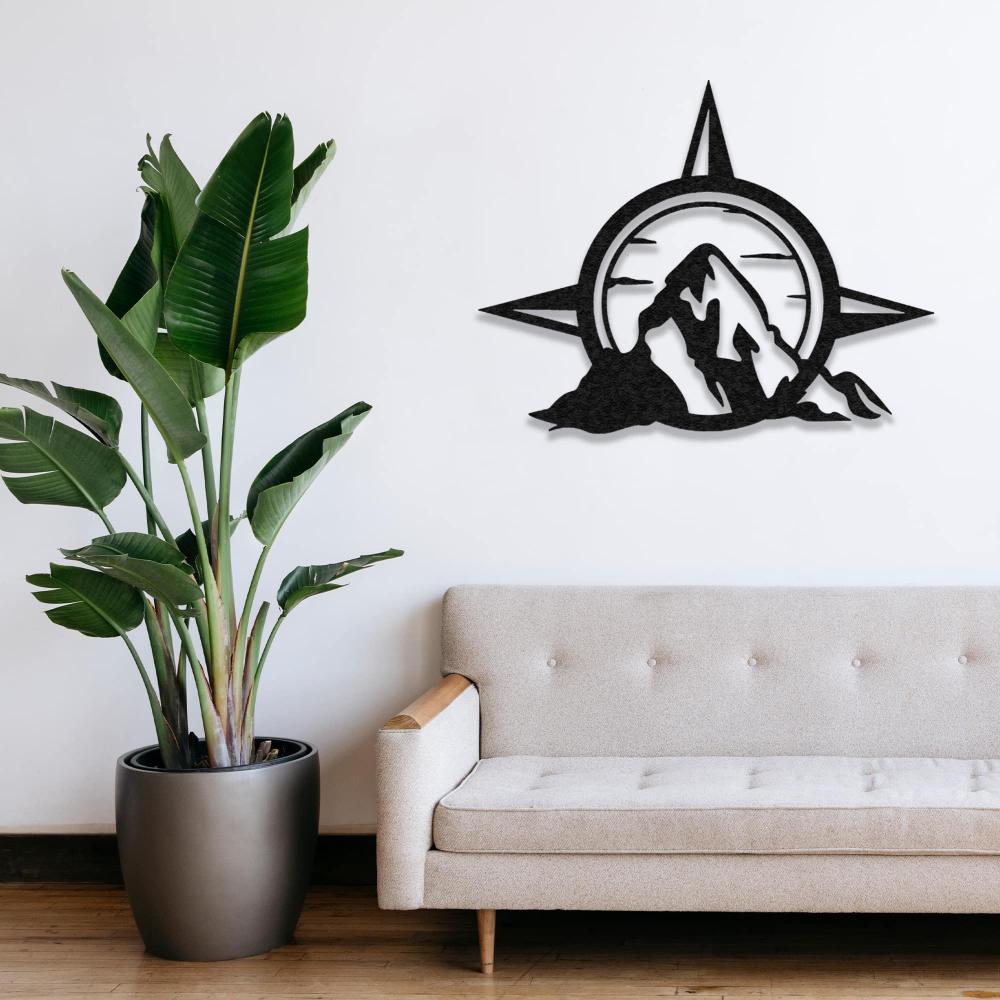 Compass and Mountain Metal Wall Art in a living room