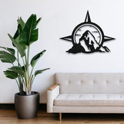 Compass and Mountain Metal Wall Art in a living room