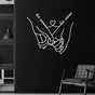 Minimalist metal wall art featuring a pair of hands holding each other, personalized with "her name" and "his name" connected by a heart, elegantly displayed against a dark wall, creating a striking contrast.