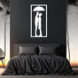 White metal wall art of a couple under an umbrella, elegantly mounted above a dark-themed bed with a minimalist bedroom design.