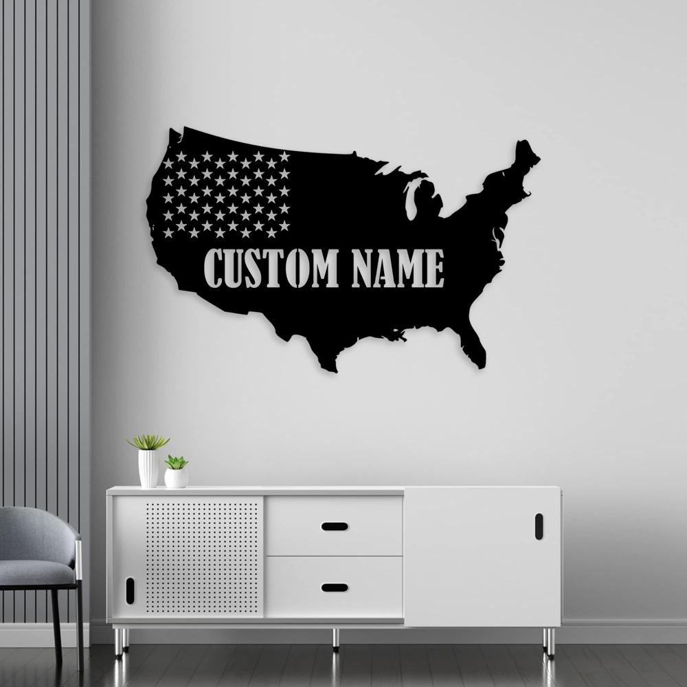 A black metal map of the USA with the text "Custom Name" mounted above a modern white sideboard in a contemporary room.