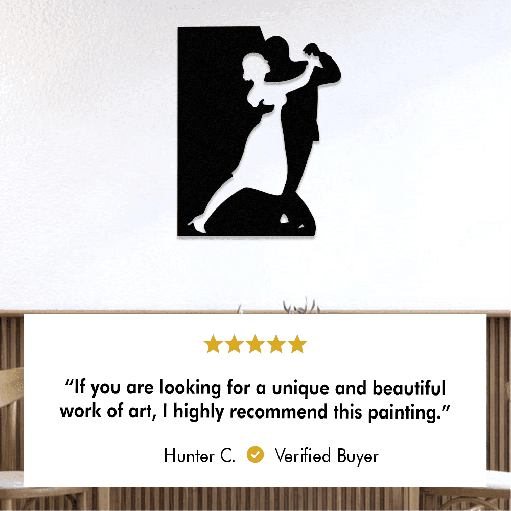 Black silhouette metal wall art of a dancing couple displayed on a white wall.