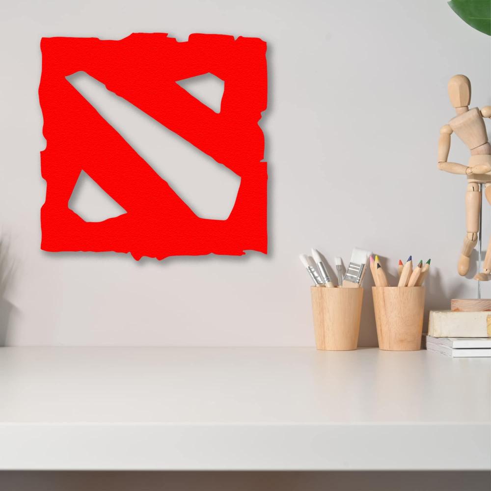 Red Dota metal wall decor displayed above a clean, minimalist desk with artist supplies, highlighting the vibrant design against a neutral wall.