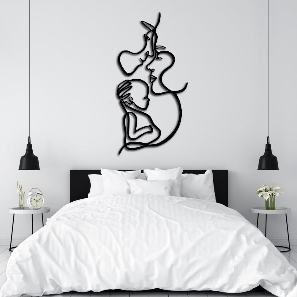 Elegant family line art metal wall decor displayed above a white bed in a modern minimalist bedroom.