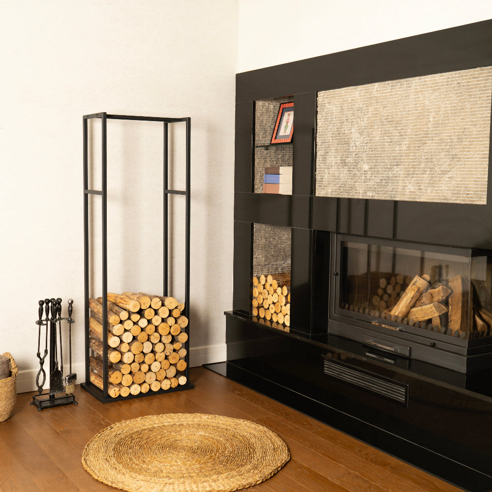 Modern living room with a black fireplace and stacked logs.
