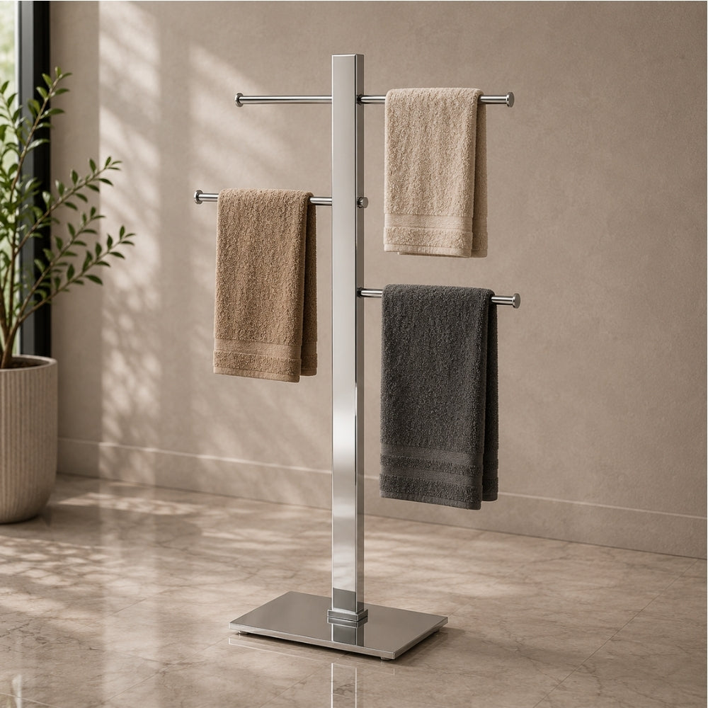 Satin nickel freestanding 3-bar towel stand holding towels in a modern bathroom.
