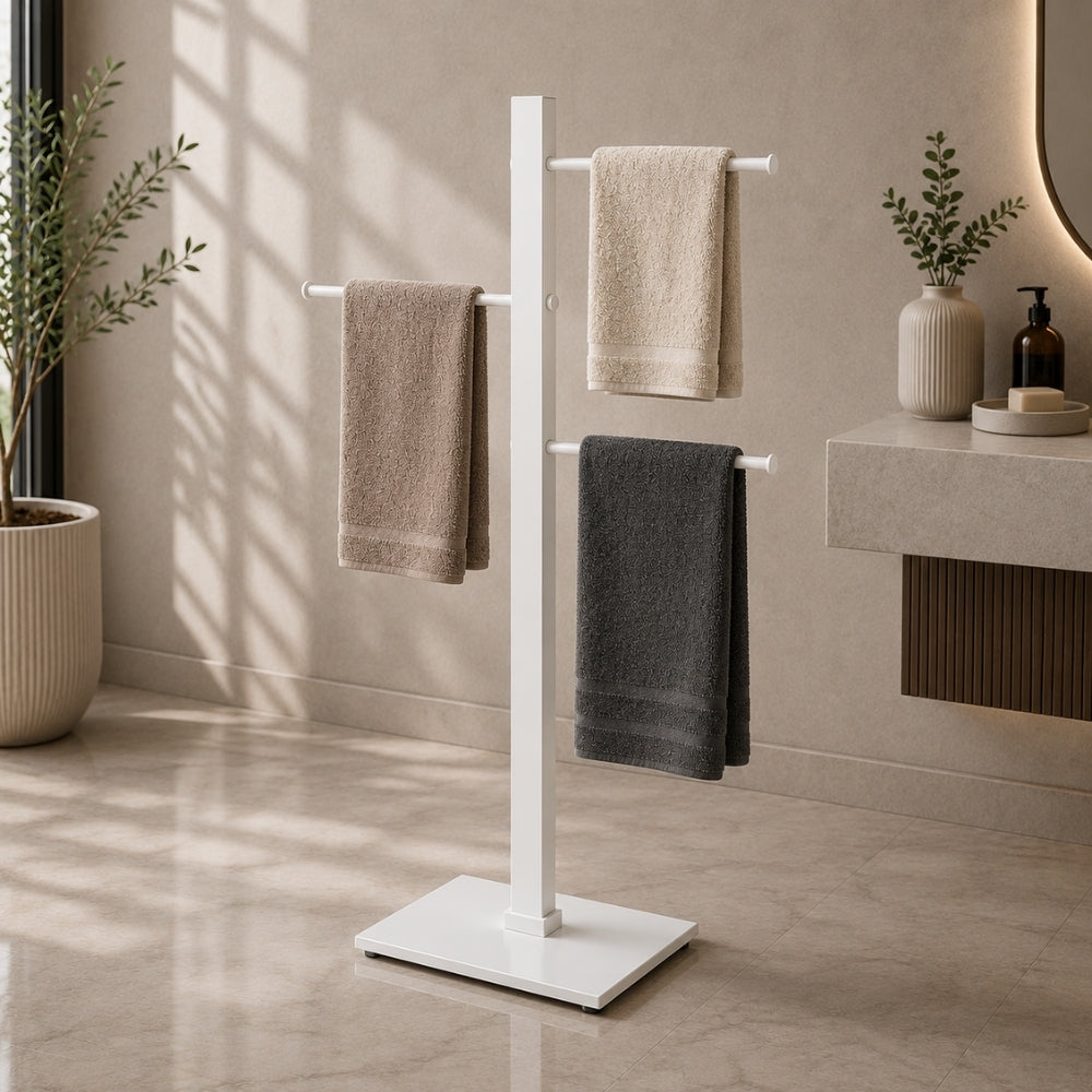 White freestanding 3-bar towel stand holding towels in a modern bathroom.