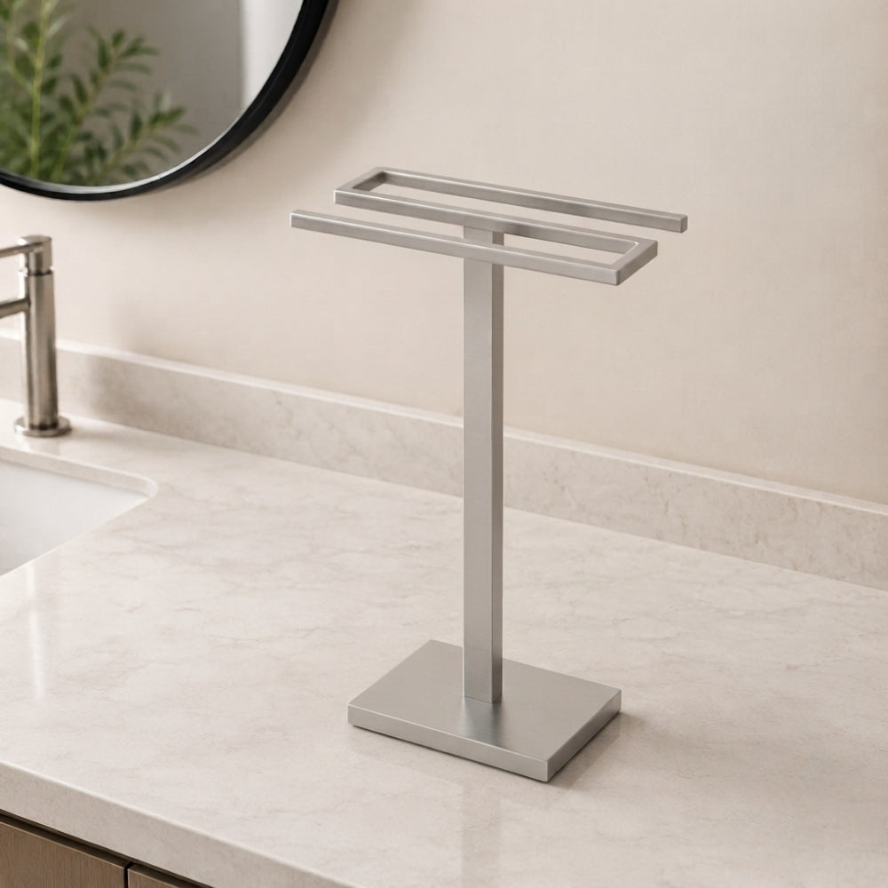 Satin nickel freestanding countertop double towel holder on a light bathroom vanity.