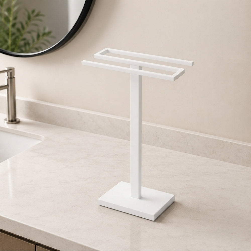 White freestanding countertop double towel holder on a light bathroom vanity.