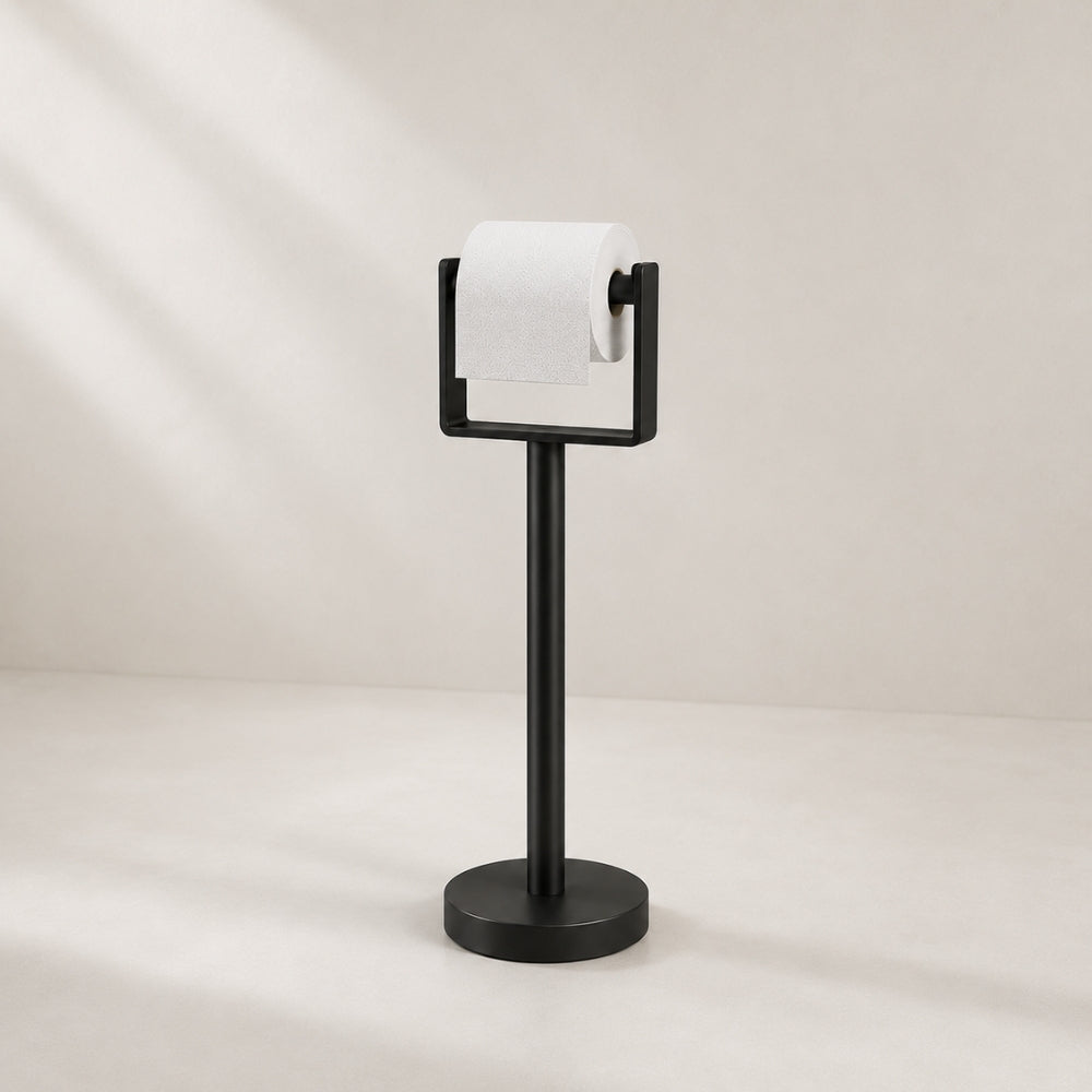 Black freestanding toilet paper holder stand holding a toilet paper roll.