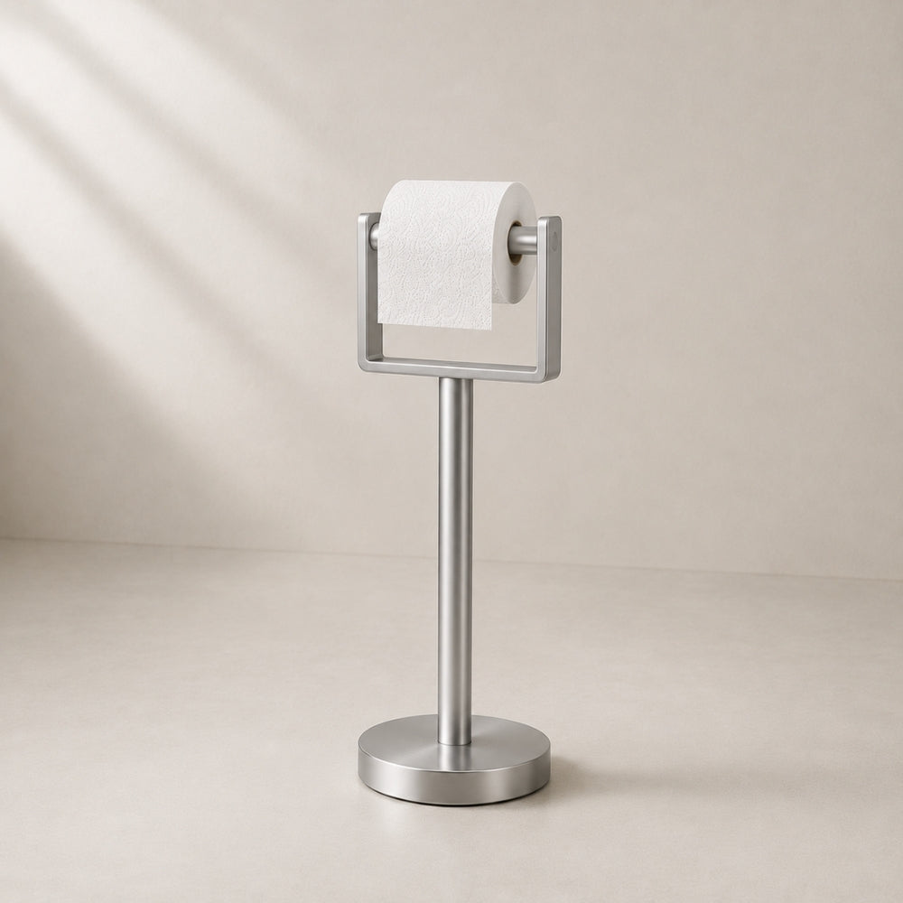 Satin nickel freestanding toilet paper holder stand holding a toilet paper roll.