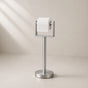 Satin nickel freestanding toilet paper holder stand holding a toilet paper roll.