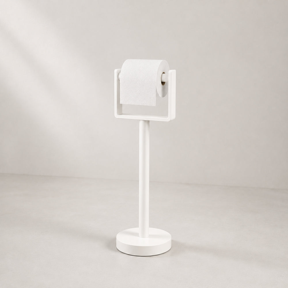 White freestanding toilet paper holder stand holding a toilet paper roll.