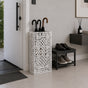 White geometric lattice metal umbrella stand in contemporary entryway with shoe storage bench